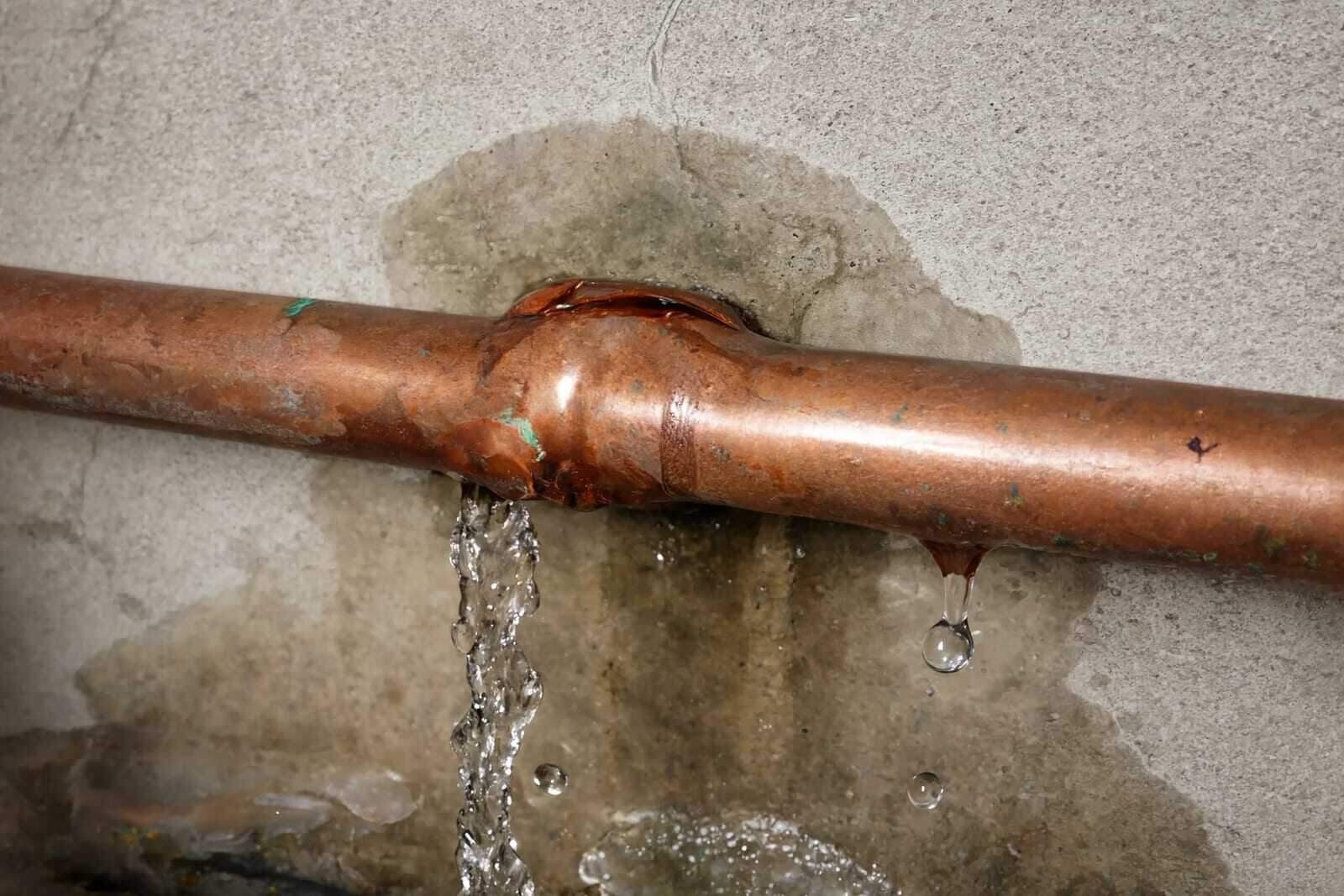 Water damage along a Houston ceiling and wall after a burst pipe