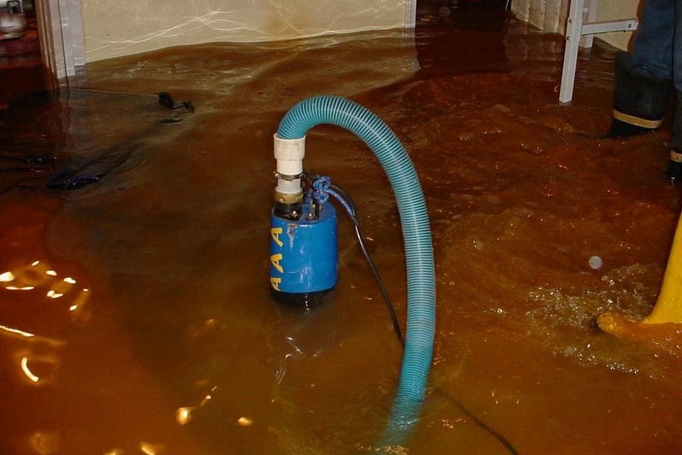 Submersible pump clearing standing water from a Houston crawlspace